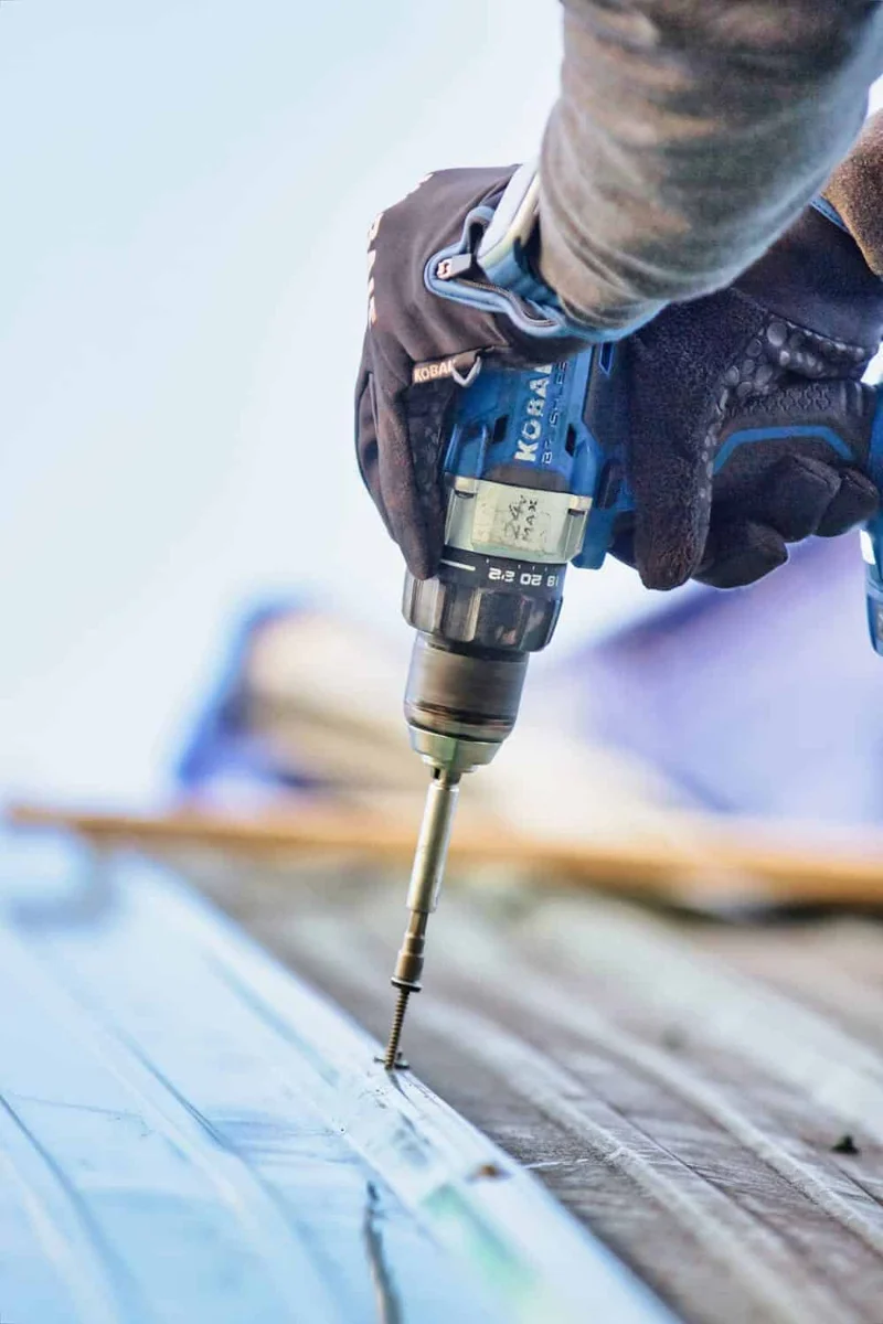 Roofing contractor working on a Utah home exterior